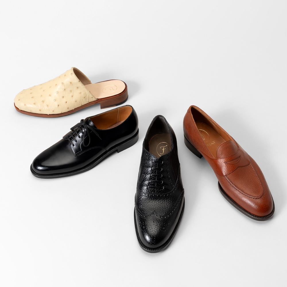 Four pairs of men's shoes on a white background: beige slip-ons, black oxfords, black brogues, and brown loafers.