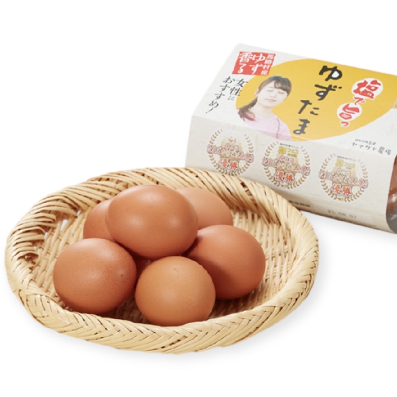 A basket with six brown eggs next to a carton featuring text and a woman's image.