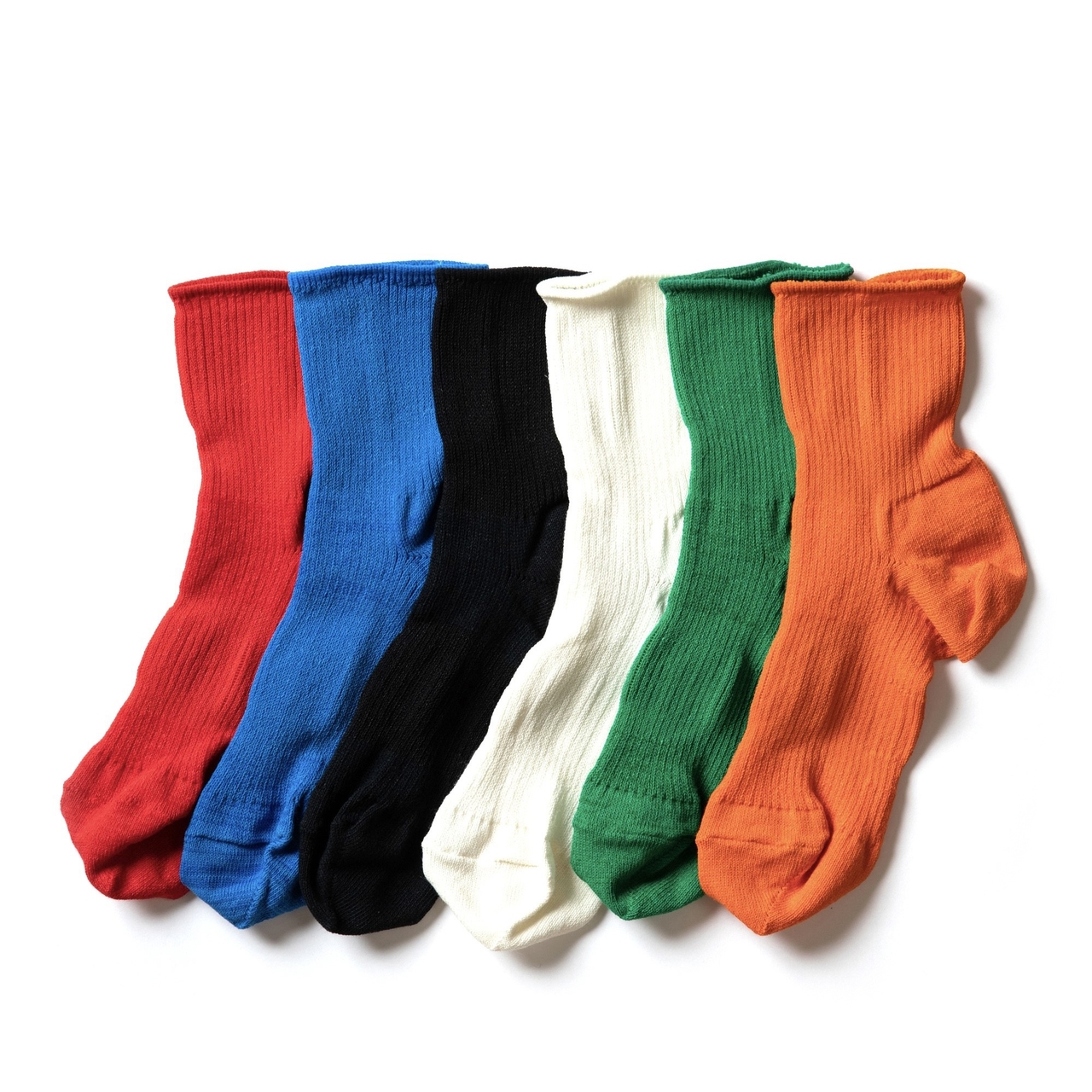 A row of six colorful socks in red, blue, black, white, green, and orange.