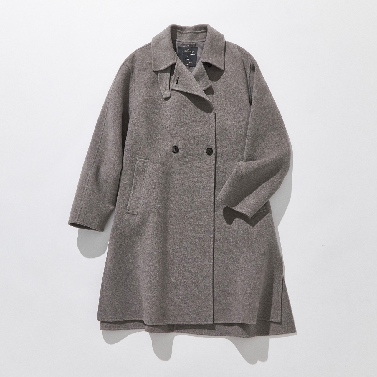 A long grey wool coat with a double-breasted design, two slanted pockets, and a wide collar, displayed on a flat white background.