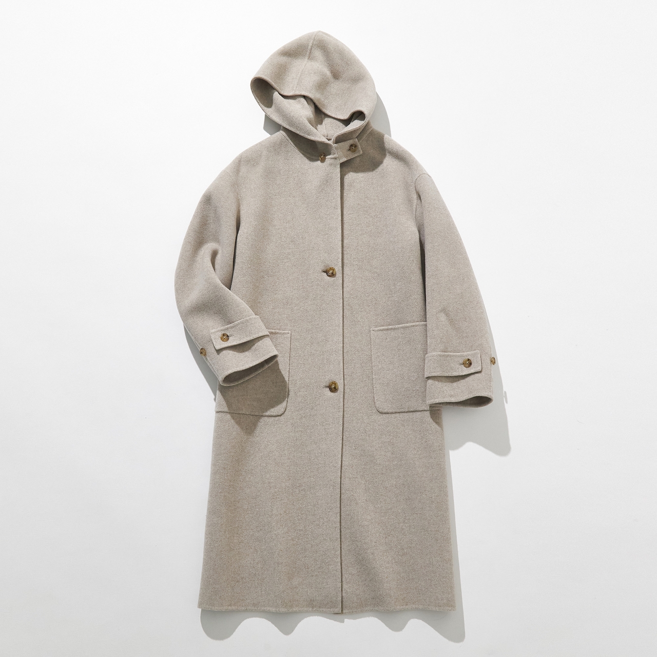 A beige hooded wool coat with front buttons and two large pockets, laid flat on a white background.