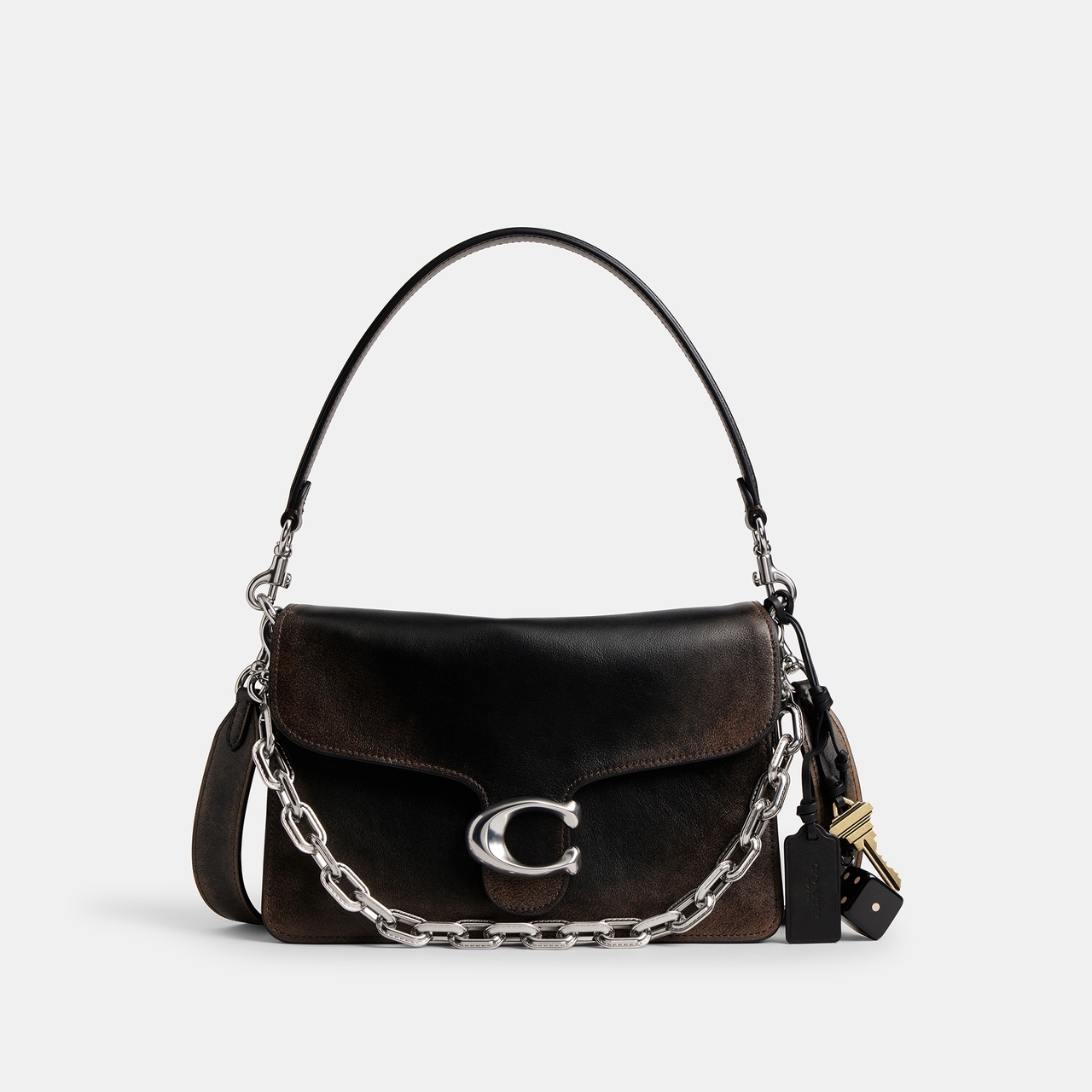 A stylish black leather handbag by COACH with a silver chain strap, featuring a prominent "C" clasp and attached charms.