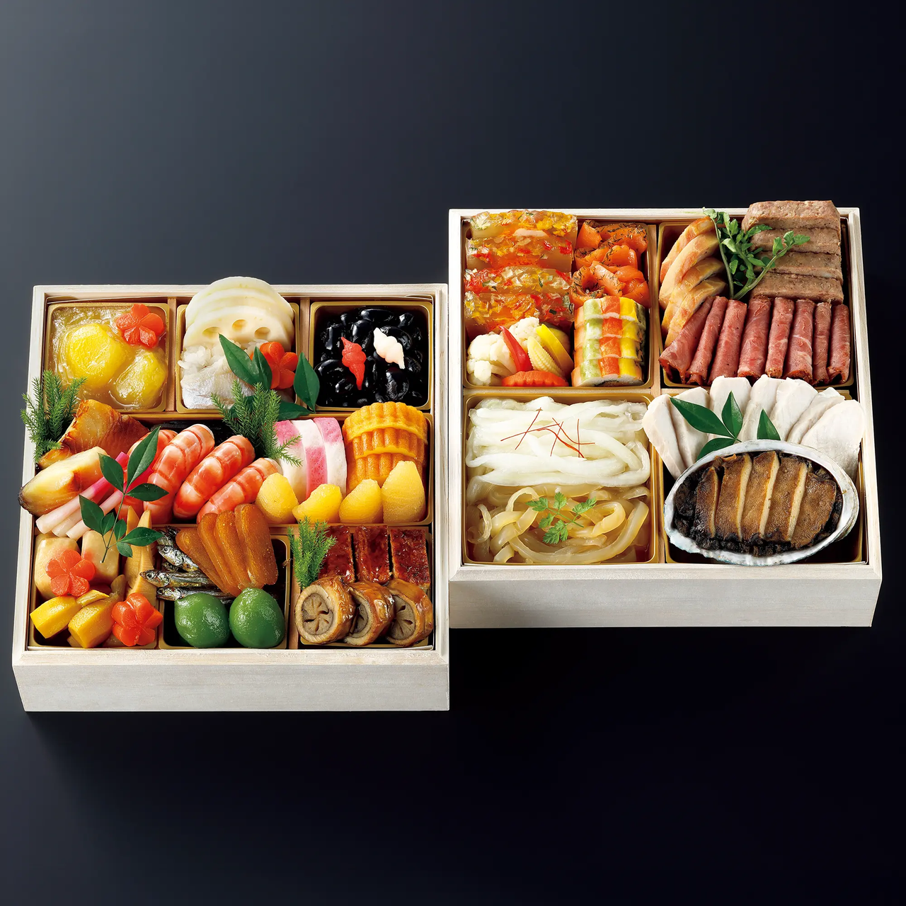Two traditional Japanese bento boxes filled with an assortment of colorful seafood, vegetables, and meats, artfully arranged on a dark background.