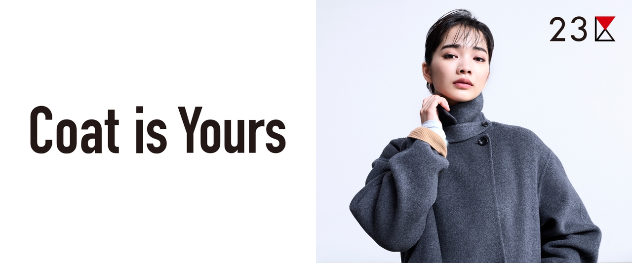 Person wearing a gray coat poses with a confident expression beside the text "Coat is Yours" and a small logo reading "23K."