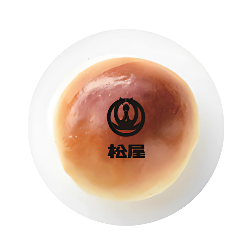A round, glossy brown pastry bun with a logo and Japanese text on top.
